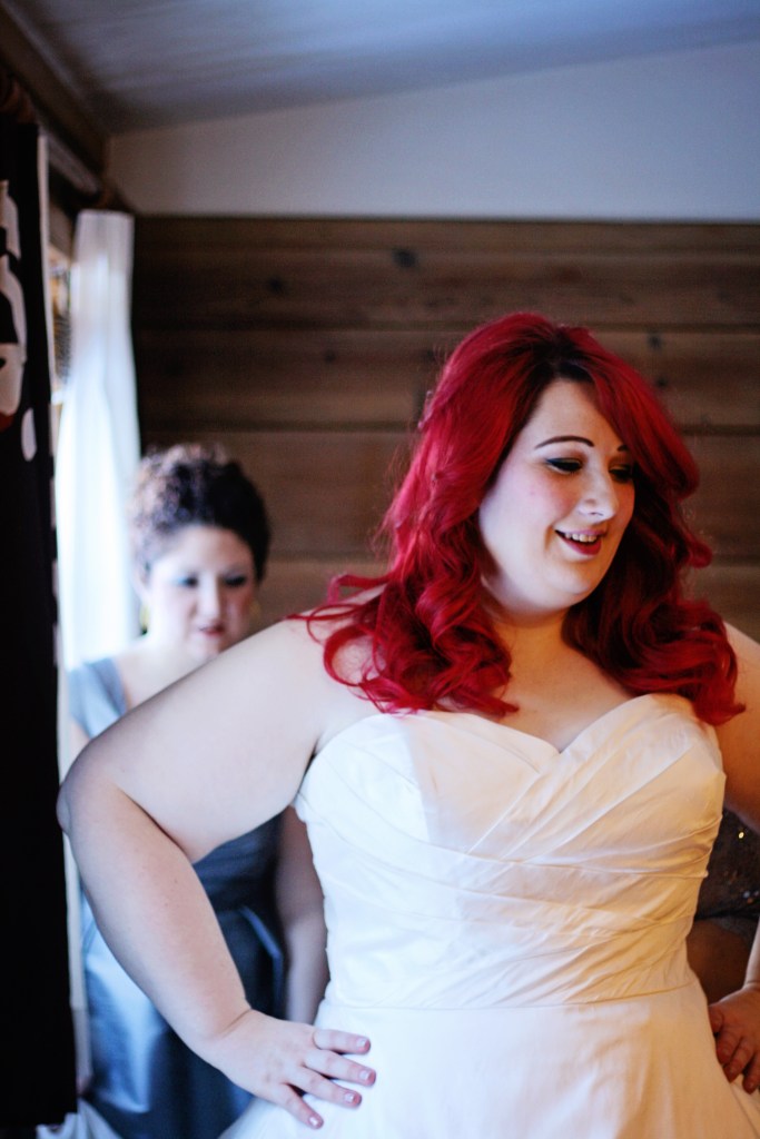 My mom and bridesmaid doing up LOTS of little buttons on the back of my dress. 